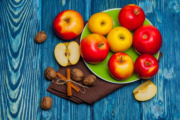 Walnut apples and cinnamon on blue wood