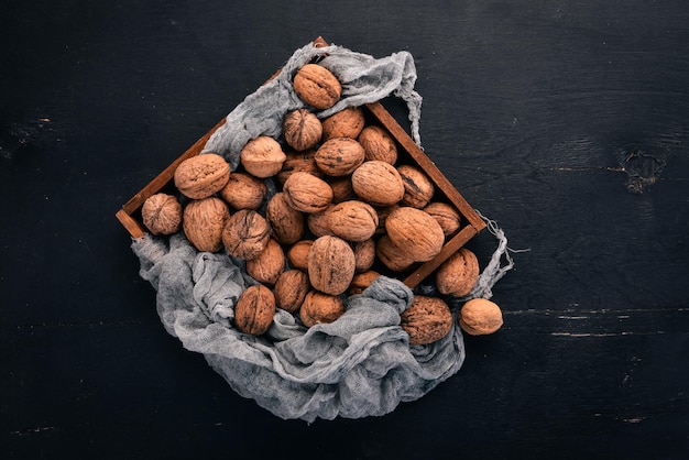 Walnut In a box on a wooden background Top view Copy space