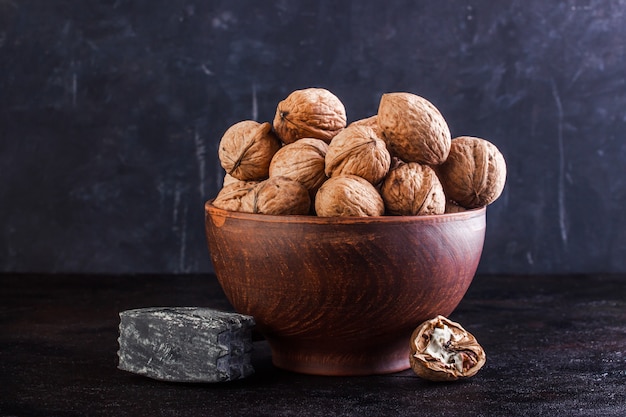 Walnut in a clay bowl, young and broken walnut