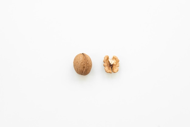 Photo walnut and a cracked walnut isolated on the white background