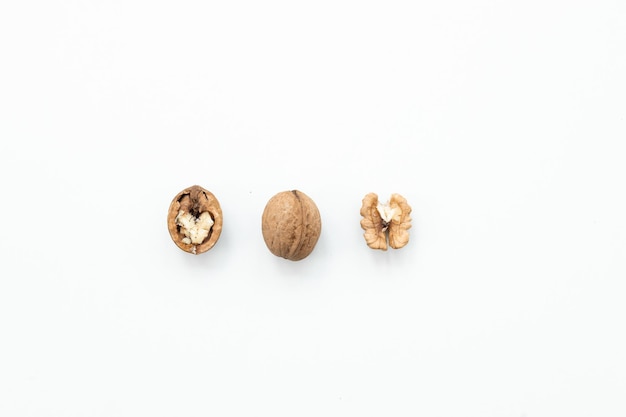 Photo walnut and a cracked walnut isolated on the white background