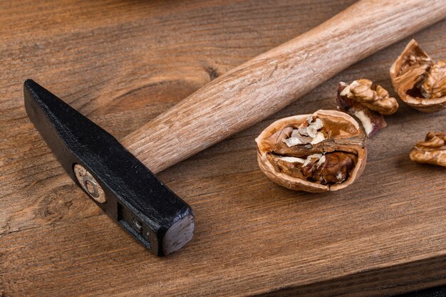 Walnut and hammer on a wooden board