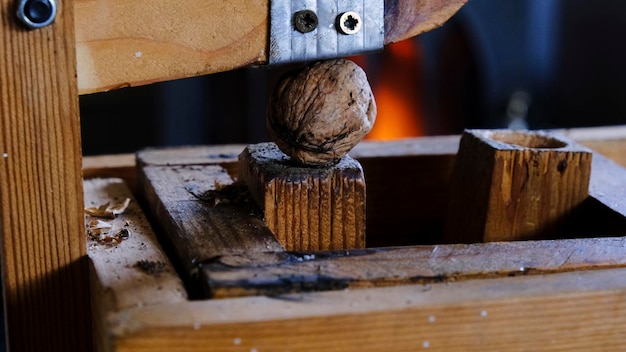 Walnut in a handmade nutcracker next to the fireplace in autumn