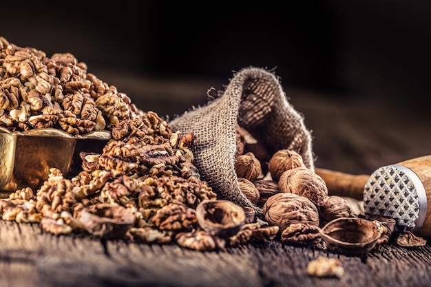 Walnut kernels whole walnuts in burlap sack and vintage bowl.