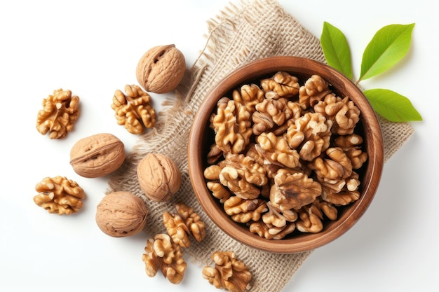 Walnut kernels and whole walnuts on white background