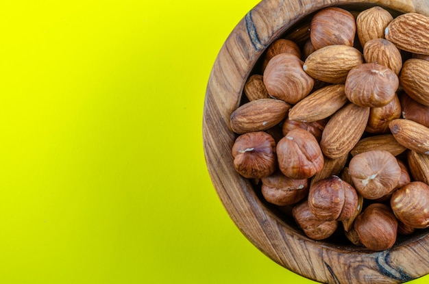 Walnut mix in a wooden plate with a place to copy.