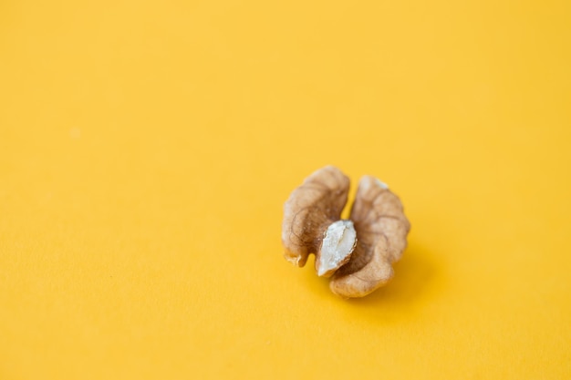 Walnut nut isolated on yellow background