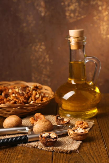 Walnut oil and nuts on wooden table