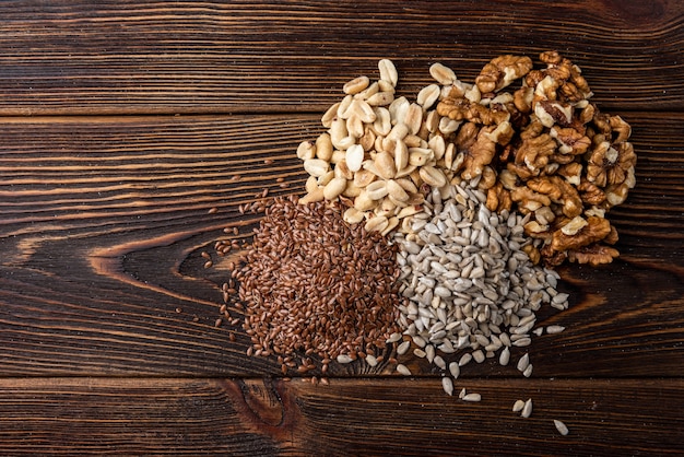 Walnut, peanut, sunflower, and flax seeds on table