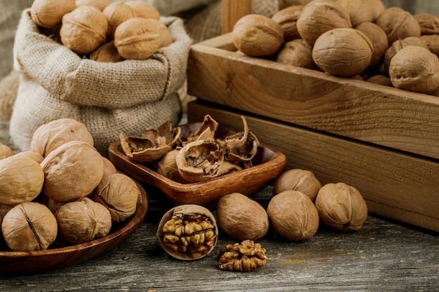 Walnuts on a dark vintage table walnut kernels in a wooden bowl Healthy foodxA