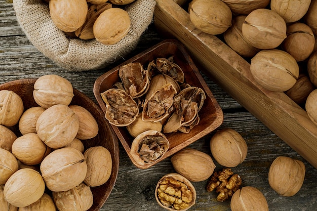 Walnuts on a dark vintage table walnut kernels in a wooden bowl Healthy foodxA