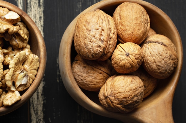 Walnuts nuts whole in wooden bowl