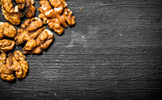 Walnuts peeled on black board