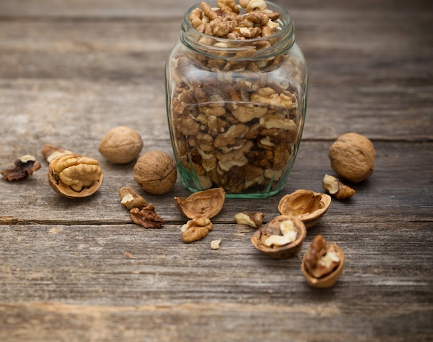 Walnuts on rustic old wooden table