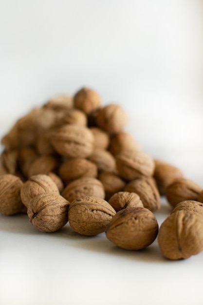 Walnuts scattered on the table on a light background