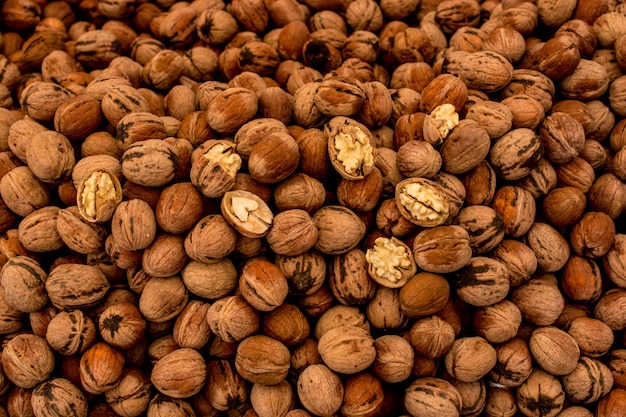 Walnuts in shell heap pattern as organic food background