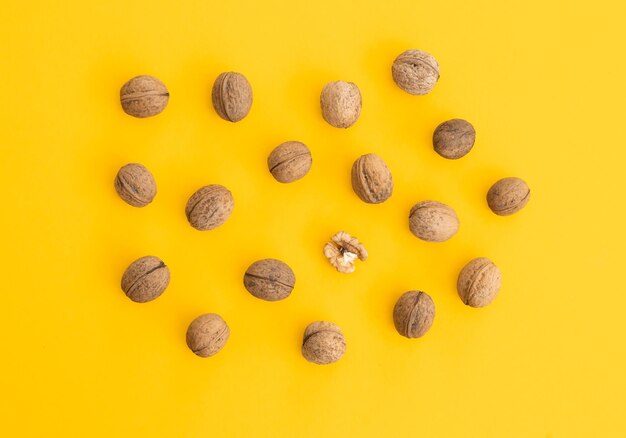 Walnuts in shell isolated on a yellow background