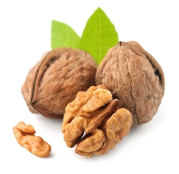 Walnuts with leaves closeup on white