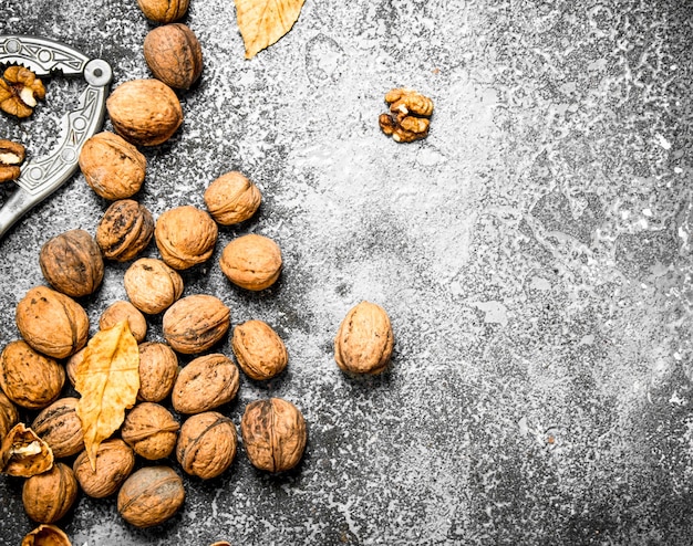 Walnuts with Nutcracker on rustic table.