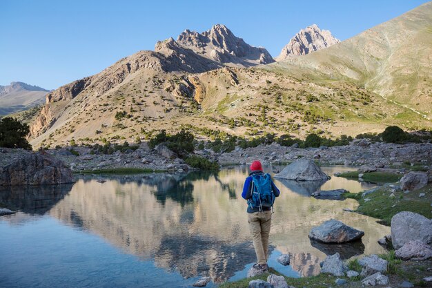 Wanderlust time. Man hiking in beautiful Fann mountains in Pamir, Tajikistan. Central Asia.