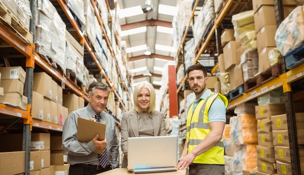 Warehouse team working together on laptop