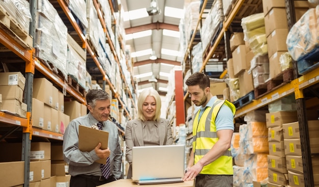 Warehouse team working together on laptop