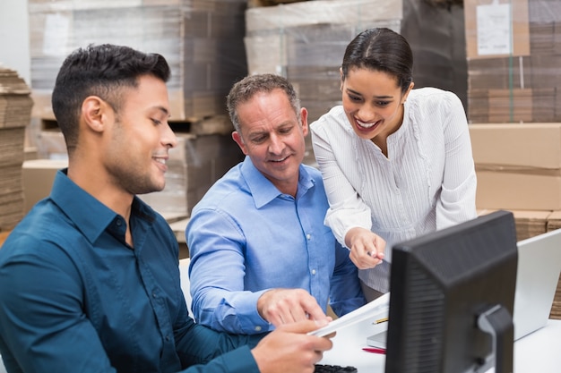 Warehouse team working together with clipboard