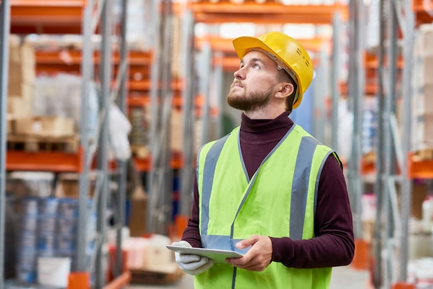 Warehouse Worker Using Digital Tablet