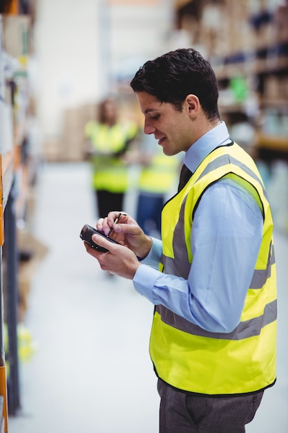 Warehouse worker using hand scanner in warehouse