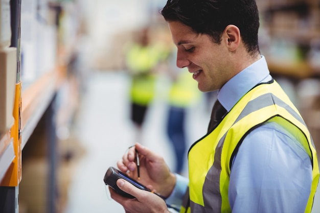 Warehouse worker using hand scanner in warehouse