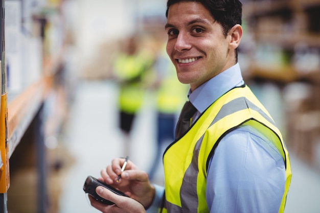 Warehouse worker using hand scanner in warehouse