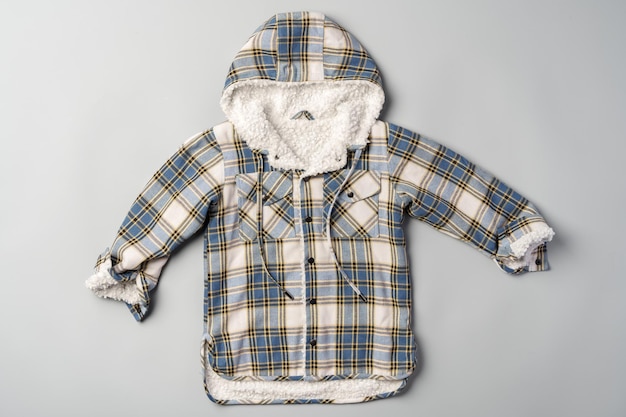 Photo warm baby coat for boys on gray background top view