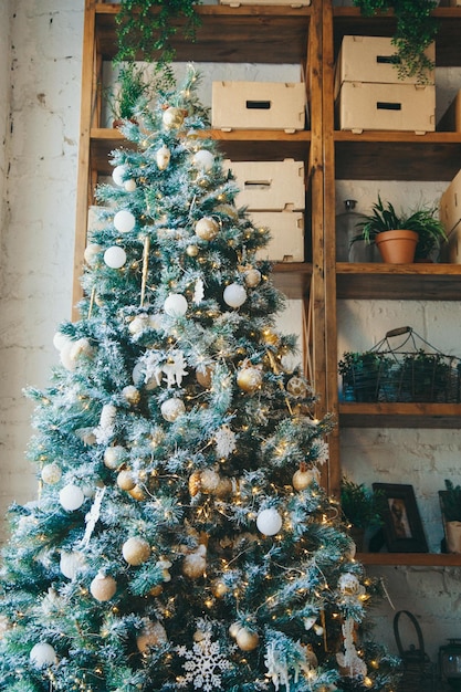 Warm cozy beautiful modern design of the room in delicate light colors decorated with christmas tree