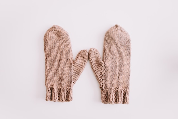 Photo warm knitted mittens isolated on white background top view