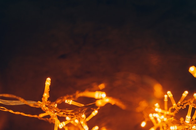 Warm light illuminated garland close up on dark background