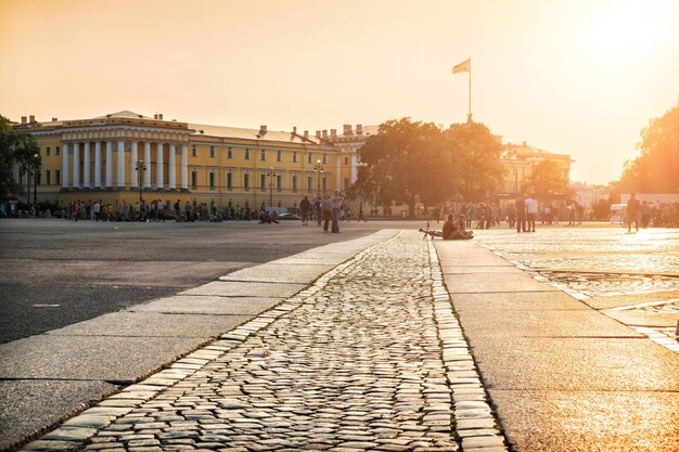 Warm paving stones at the Palace Square in St. Petersburg, and a crowd of people