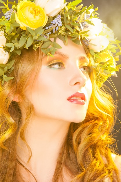 Warm portrait of sensual woman with flowers in studio