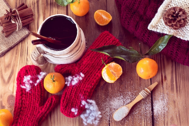 Warm winter with mittens, tea and tangerines