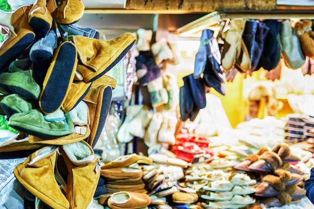 Warm woolen slippers displayed for sale at the stall during the Christmas market in Riga, Latvia. Selective focus