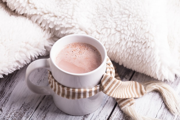 Warming drink - cup of cocoa with milk on the table