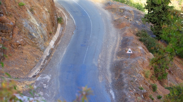 Warning signal, double bend, first to left, Road sign used in Morocco