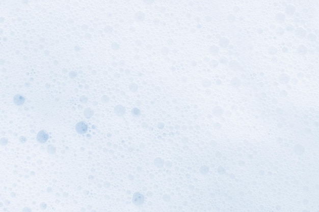 Washing agent foam in a Petri dish On a blue background