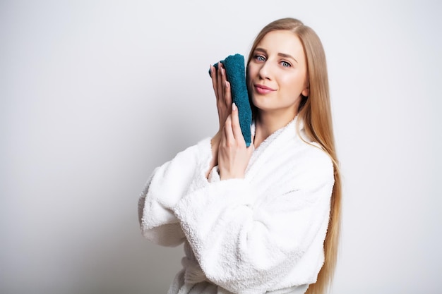 Washing face, portrait woman cleaning skin with towel.