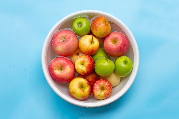 Washing fresh apples in the water in a bowl