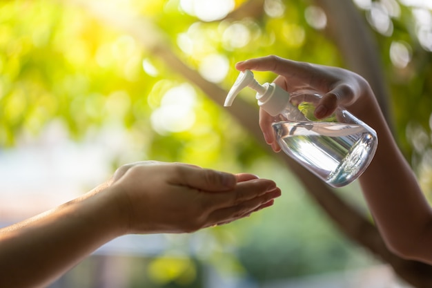 Washing hands by alcohol sanitizers.