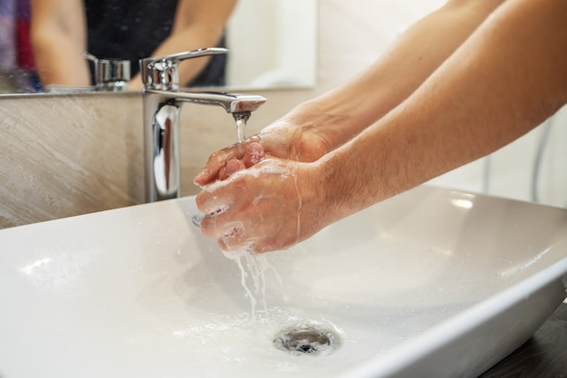 Washing hands rubbing with soap man for corona virus prevention, hygiene to stop spreading coronavirus.