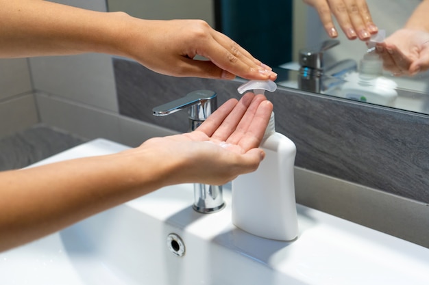 Washing hands rubbing with soap woman