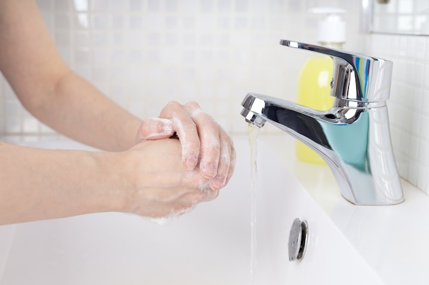 Washing of hands with soap under running water