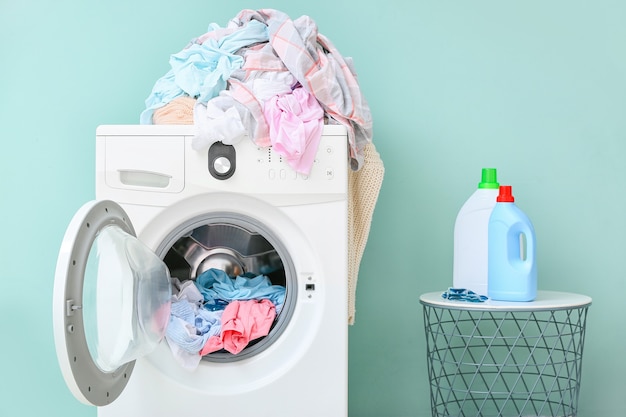 Washing machine with dirty clothes and detergents in home laundry room