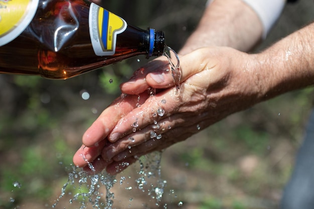 Washing your hands with bottled water at a picnic High quality photo